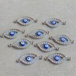 CONECTOR OJO TURCO AZUL STRASS SILVER x 12 UNIDADES( 12x27x3mm APROX.).