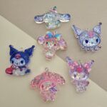 DIJE RESINA CON GLITTER 43*47MM X 12 UNIDADES SURTIDO. (EMA 5-9)