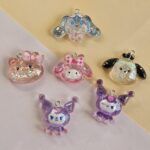 DIJE RESINA CON GLITTER 27*28MM X 12 UNIDADES SURTIDO. (EMA 5-10)